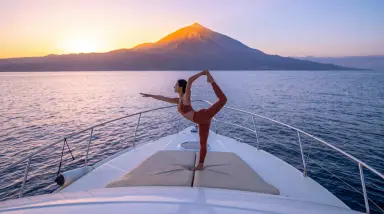 Woman Practicing Yoga on Boat at Sunset