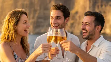 friends toasting champagne at beach sunset